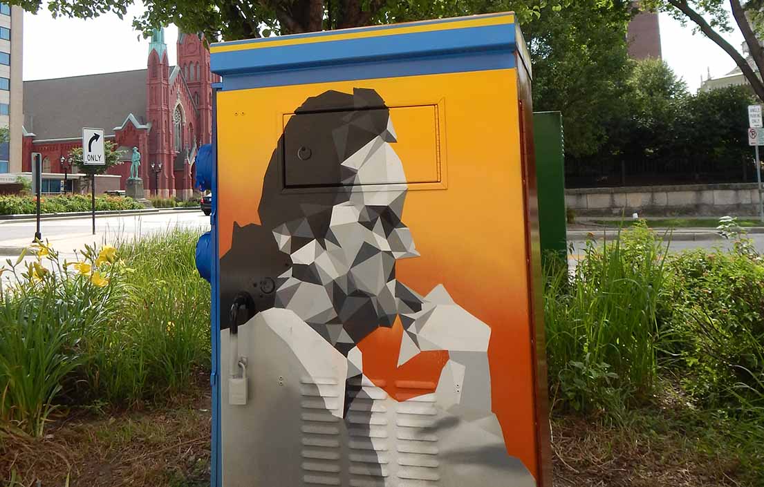 A side profile of Al McGuire on a utility box mural.