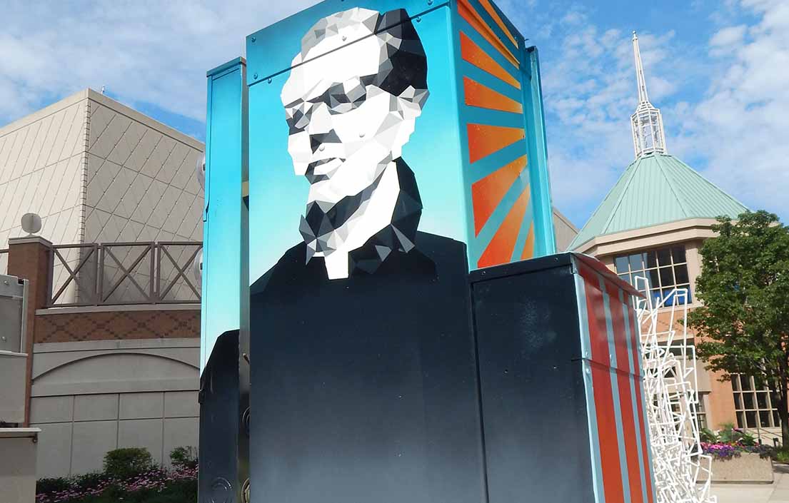 A portrait of Father James Groppi on a utility box mural.