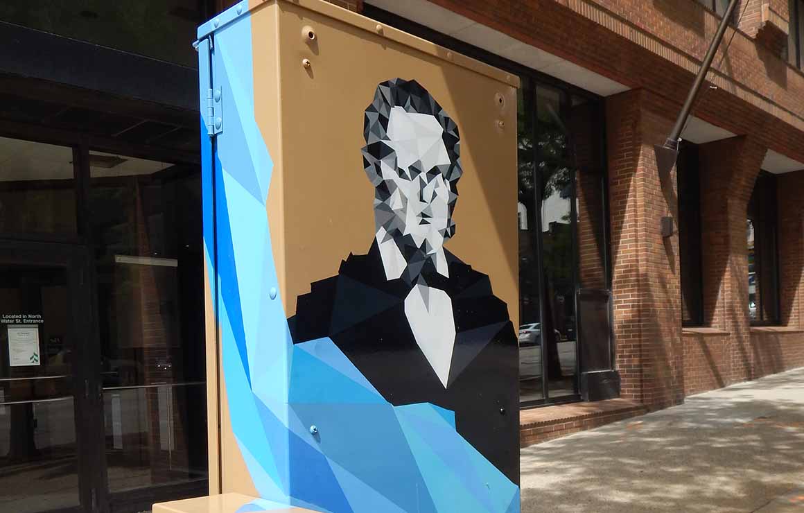 A portrait of Byron Kilbourn on a utility box mural.