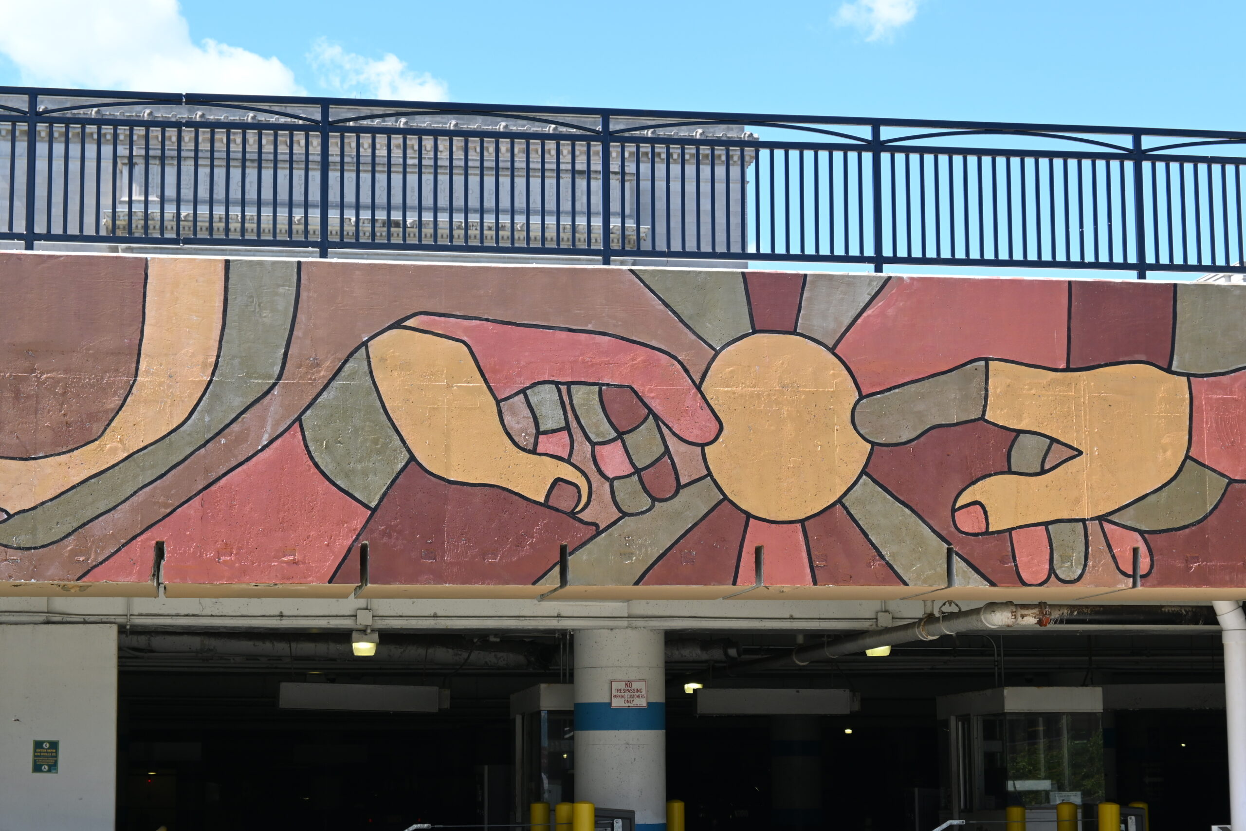 A portion of the Hero in You mural features two hands.