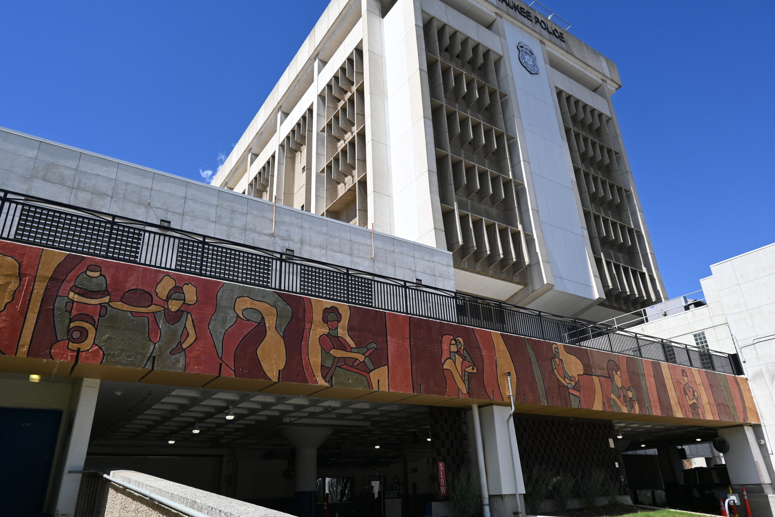 The Hero in You mural with the police building in the background.