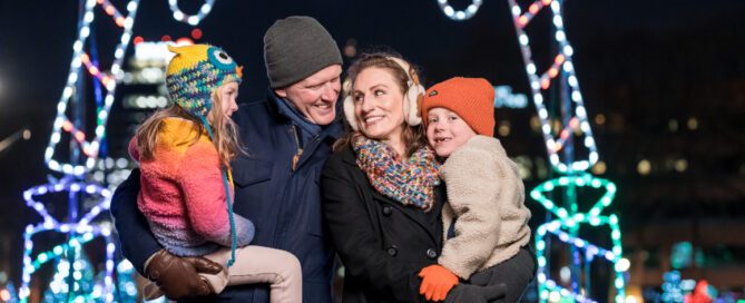 A family of four at the Holiday Lights Festival.