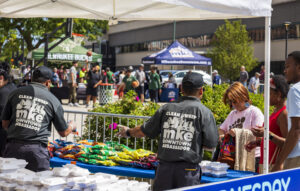 MKE Bid 21 ambassadors handing out food