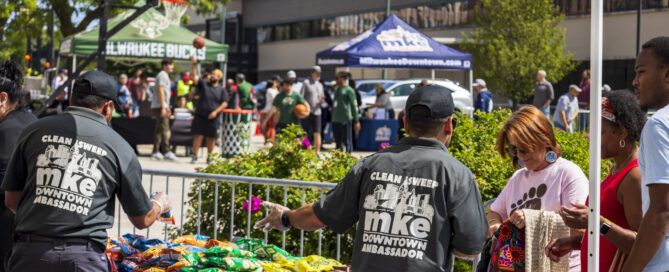 MKE Bid 21 ambassadors handing out food