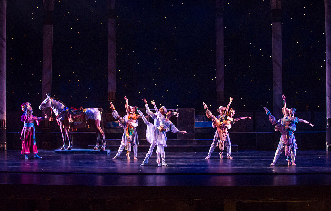A group of ballet dancers on stage.